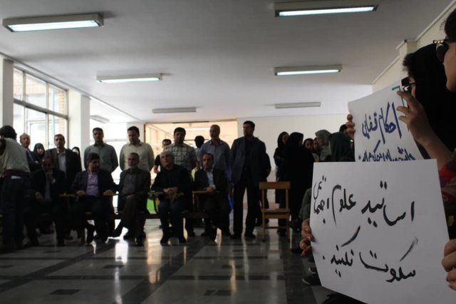 Students and professors gather to protest at a university in Iran