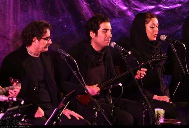 Contemporary Iranian music singers Shahram Nazeri (left) and Hafez Nazeri (middle) perform at a concert.