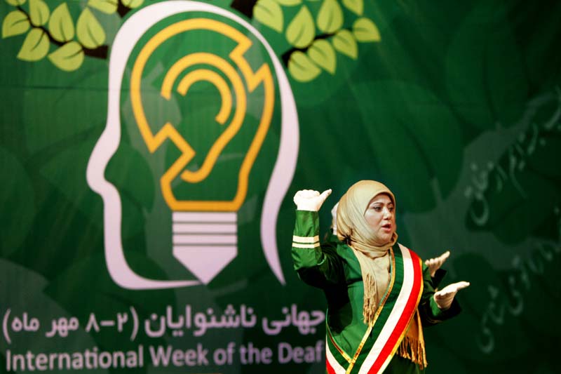 Sign language interpreters at a gathering in Tehran on the occasion of 2018’s International Week of the Deaf.