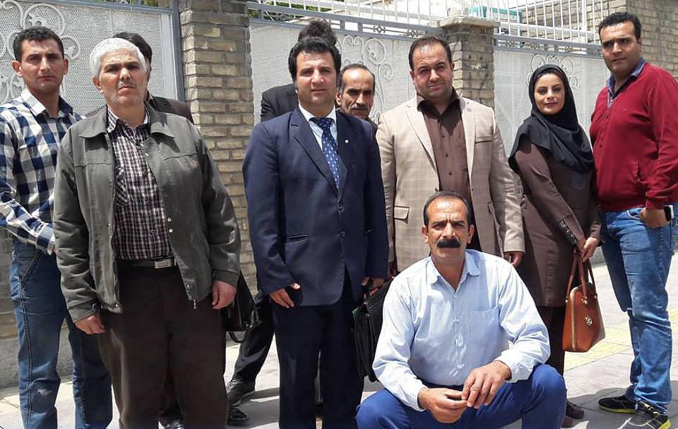 Human rights lawyer Mohammad Najafi (center in a blue suit) poses for a photo with some of his clients and colleagues at an unknown location in the city of Arak. Najafi has been sentenced to three years in prison and 74 lashes for accusing local police of killing a young man who was taken into custody earlier this year. No one has been held responsible for the death of the detainee, 22-year-old Vahid Heydari.